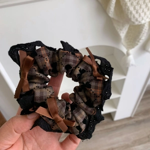Brown plaid scrunchie with black lace trim and three satin bows for ponytail styling
