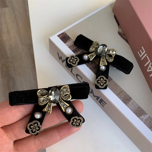 Elegant black velvet bow hair clip with vintage gold metal and pearl crystal details