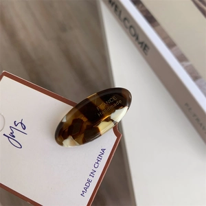 Detail of tortoise shell acetate hair clip with golden France Handmade lettering