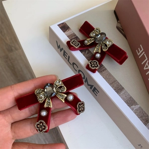 Elegant red velvet bow hair clips with pearls and crystals in a vintage luxury style