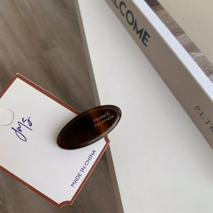Detail of tortoiseshell acetate duckbill hair clip with France Handmade gold lettering