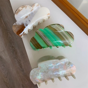 Chic cloud-shaped acetate hair claw clips in marble brown, striped green, and pearly white