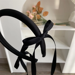 Elegant black ribbon bow headband with long streamers in ballet style for women