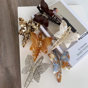 Detail shot of acetate butterfly hair claws in six elegant marbled textures and colors