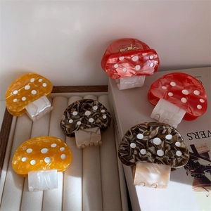 Chic acetate mushroom hair claws with polka dots in yellow, red and tortoise colors