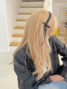 Elegant black ribbon bow headband with long streamers on blonde hair for balletcore style