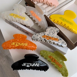 Colorful acetate claw clips with Je T'aime lettering in various marble and solid finishes