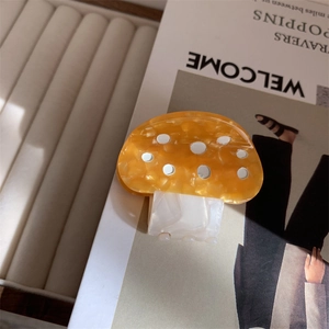 Detailed view of colorful mushroom hair claw clip made of acetic acid plate material