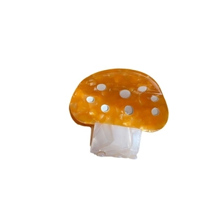 Colorful mushroom hair claw clip made of orange acetate with marble texture and white dots