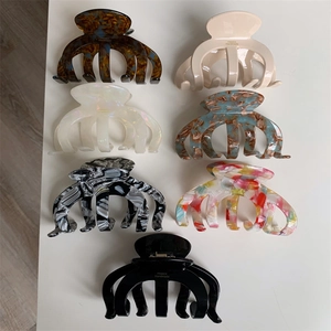 Set of seven large acetate shark hair claws in varied tortoise and marble patterns