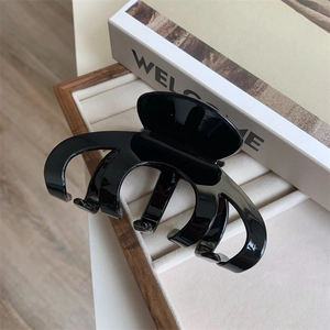 Large black acetate hair claw clip with glossy finish for elegant hairstyling
