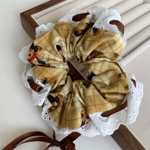 Japanese style yellow bear scrunchie with brown ribbon and lace edge detail