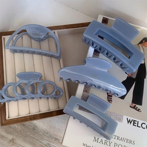 5-piece set of smoky blue acetate hair claws in various geometric shapes with gold lettering