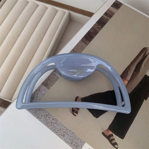 Detailed macro of dusty blue acetate hair claw clip with gold FRANCE Handmade lettering