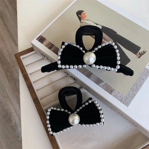 Elegant black velvet bow hair claw clips with pearl edges and center accents for women