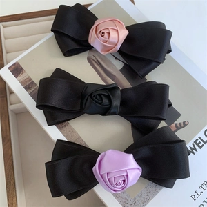 Three elegant 3-layer silk bow hair clips with rose accents in pink, black, and purple