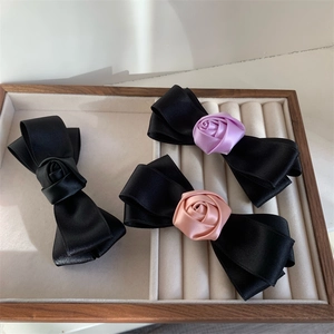 Elegant black satin ribbon bow hair clips with silk rose accents in three colors