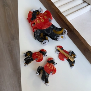 Set of Christmas dog hair clips featuring festive red sweaters and amber acetate textures