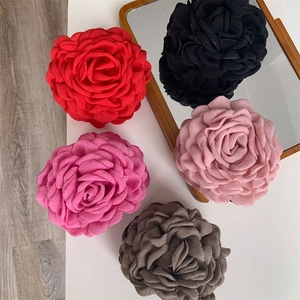 Detail view of 3D fabric rose hair claws in various elegant colors for hair styling