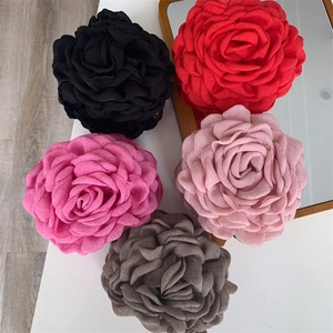 Macro detail of high-quality large fabric rose hair clips in five different colors