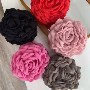 Macro detail of layered fabric 3D rose hair clips in diverse colors with textile texture