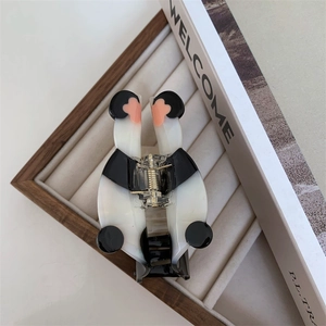 Detail view of panda shaped acetate hair claw clip with pink blush on jewelry display