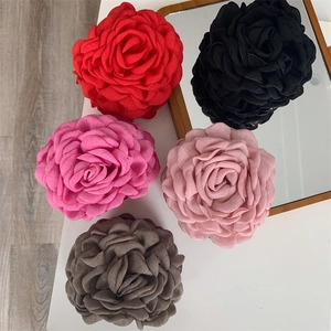 Detailed view of large fabric flower hair claws in five colors like dusty rose and black
