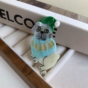 Detail of Christmas Pug acetate claw clip showing green hat and blue sweater texture