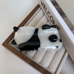 Detailed macro view of the pearlescent black and white panda acetate hair claw clip