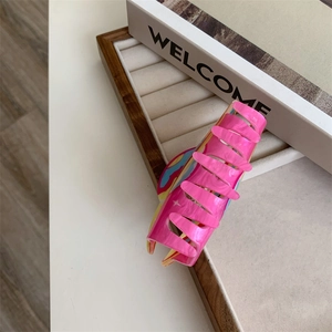 Detailed close-up of pink acrylic hair claw clip with colorful artistic graffiti texture