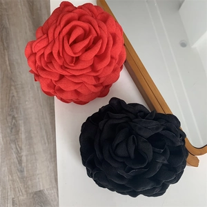 Detailed close-up of multilayer rose hair claw clips in red and black colors