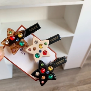 Lot de 3 barrettes en forme d'étoile avec strass colorés en noir, crème et écaille