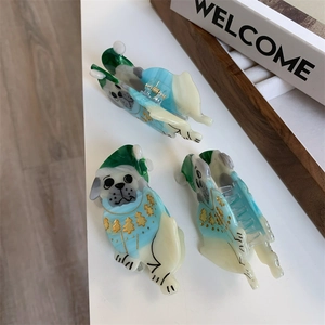 Close-up of festive pug dog hair clips made of colorful acetate with a porcelain finish