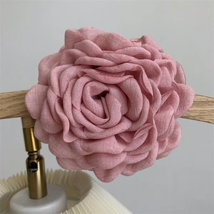 Close-up of elegant dried rose fabric hair claw clip with vintage pink floral details
