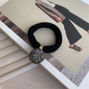 Detail of high-elastic black hair tie with sparkling dark grey rhinestone ball charm