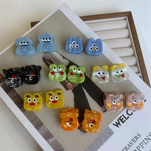 Colorful monster acetate hair claws set featuring cute cartoon eyes in eight vibrant colors