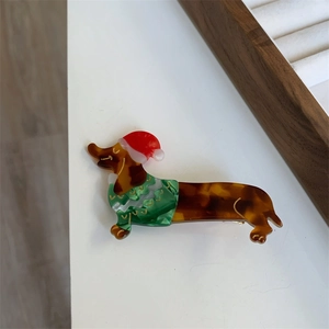 Detailed view of dachshund hair claw made of tortoiseshell acetate with Christmas hat