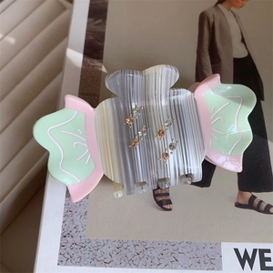 Cute candy-shaped acetate hair claw with pastel color blocking and sparkling rhinestones