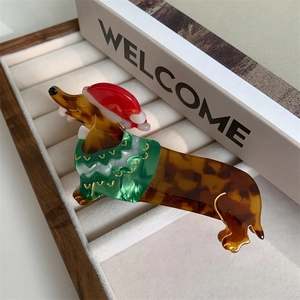 Detail of Christmas dachshund hair claw clip with acetate finish and festive sweater design