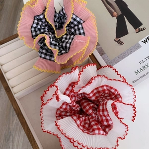 Set of two lace pleated scrunchies with pink and red plaid patterns on a white jewelry tray