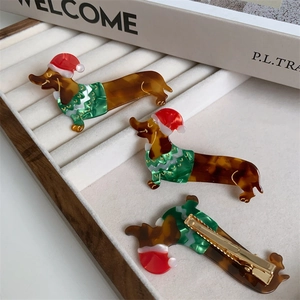 Detail of Christmas dachshund hair clip showing the back side metal duckbill clip structure