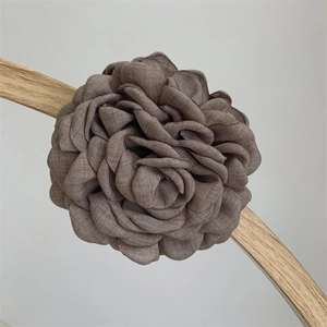 Detailed close-up of handmade fabric rose hair claw clip in vintage dusty rose linen