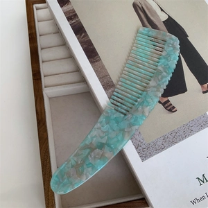 Elegant mint green marble acetate hair comb with an ergonomic long handle design