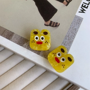 Detail shot of funny yellow monster acetate hair clips with unique marble textures