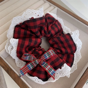 Red plaid scrunchie with white lace edges and a small bow tie for women's hair styling