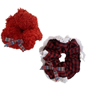 Red plush and plaid scrunchies with lace edges and festive bows for long hair