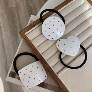 Three-piece set of elegant hair ties featuring heart and geometric shapes with colorful rhinestones