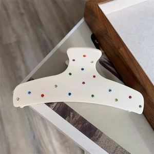Elegant cream acetate hair claw clip with colorful rhinestones in a minimalist design