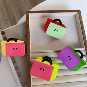 Colorful acetate handbag-shaped hair claws set in four different vibrant color combinations