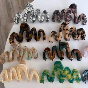 Flat lay of diverse acetate claw clips featuring marble and tortoise shell patterns